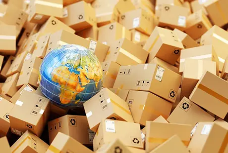 A globe in between multiple carton boxes